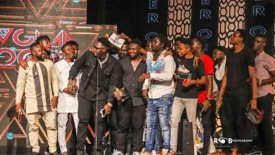 Medikal and the AMG Business team giving acceptance speech after receiving award